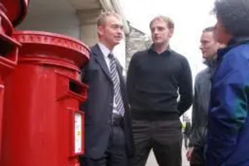 Tim Farron with local residents at a Post Office