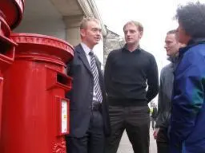 Tim Farron with local residents at a Post Office