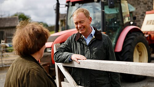 Tim listening to a farmer