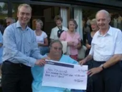 Tim presenting a cheque to the New Holehird charity