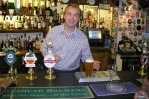 Tim pulling pints in the Sun Inn, Coniston