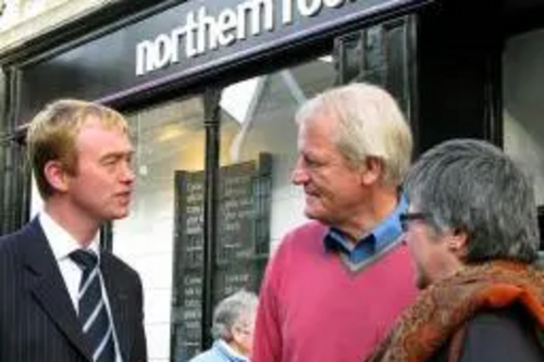 Tim speaking to local residents outside a bank