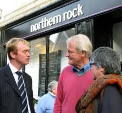 Tim speaking to local residents outside a bank