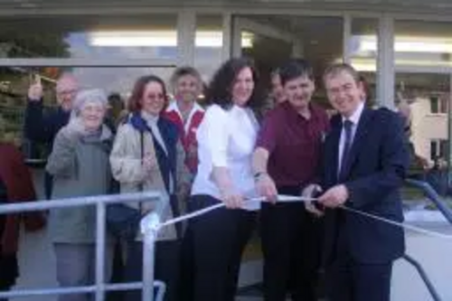 Tim is photographed with Bill Riddell the new owner of Oxenholme Post Office and Stores cutting the ribbon to open the store.