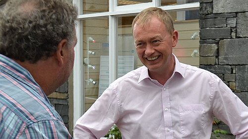 Tim Farron listening to a local resident