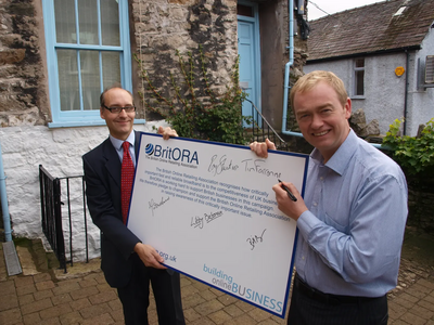 Tim Farron MP signing the BritORA broadband petition with Adrian Quine. 