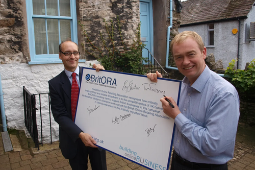 Tim Farron MP signing the BritORA broadband petition with Adrian Quine. 