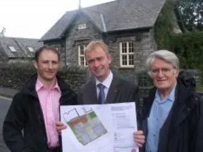 Tim Farron and Cllr Colin Davies view plans for new affordable housing in Hawkshead