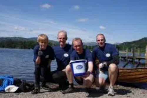 Tim Farron MP and local councillor Steve Coleman with support runners on shore of Windermere